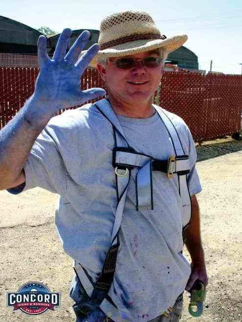 Tim Taylor - your local Concord sign making expert poses after completing a sign project.