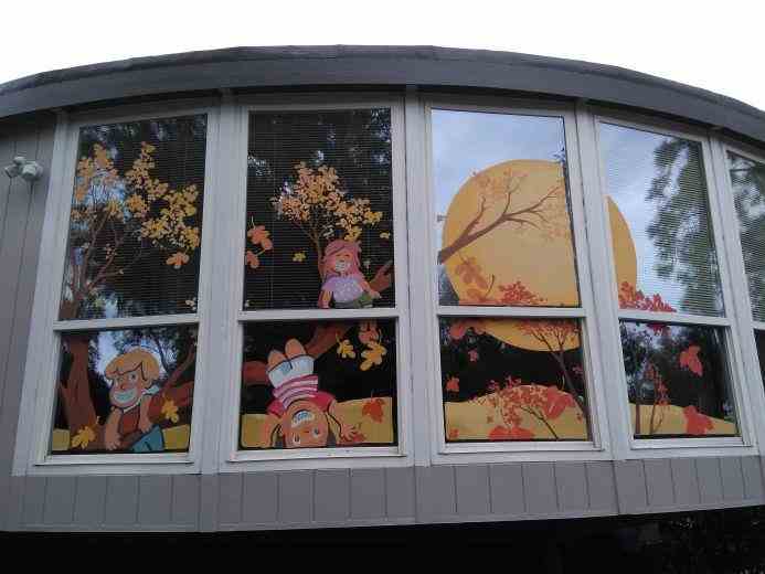 Custom hand-painted window signage for a pediatric orthodontist, designed to create a fun and welcoming environment, making the office less intimidating for kids