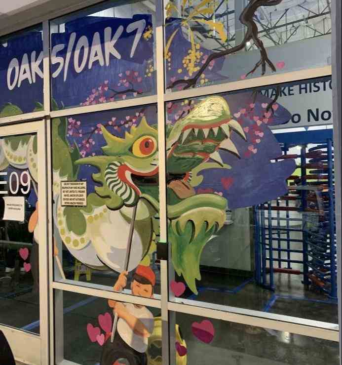 Custom window signage combining hand-painted artwork and perforated vinyl, allowing customers inside the business to see outside while enhancing storefront visibility from the street