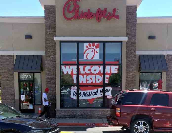 Chick-fil-A storefront window displaying 'Welcome Inside, We Missed You' signage