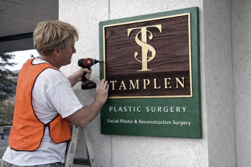 Custom sandblasted redwood outdoor sign with gold leaf lettering in San Francisco