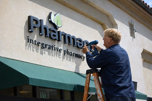 Storefront sign installation on an exterior wall