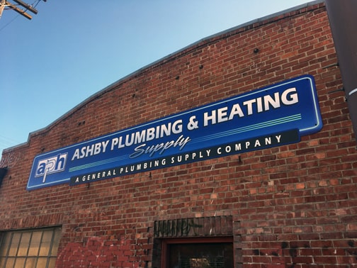 Storefront building sign mounted on brick facade