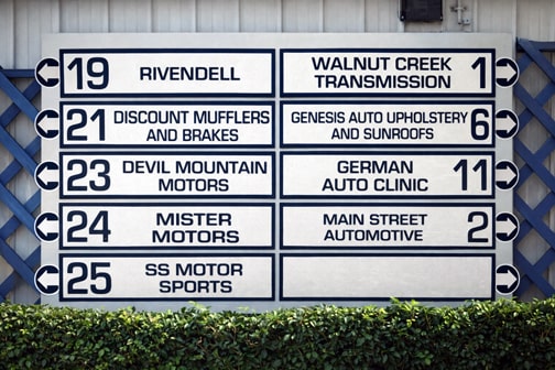 Wayfinding directory sign listing businesses on a commercial property